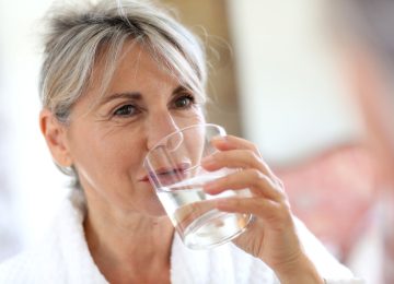 Senior woman drinking water in the morning